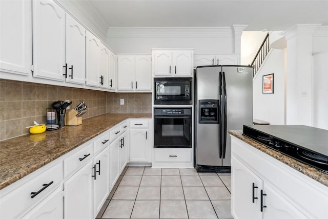 6100 Open Range Trl, Austin, TX 78749 - kitchen with black appliances, white cabinetry, dark stone countertops, backsplash, and light tile patterned floors