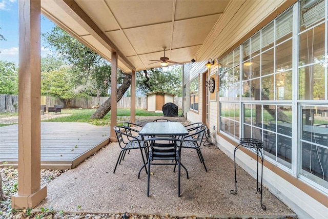 6100 Open Range Trl, Austin, TX 78749 - fenced backyard with a shed, ceiling fan, a wooden deck, and outdoor dining area