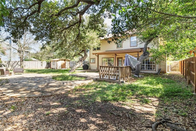 6100 Open Range Trl, Austin, TX 78749 - back of house featuring a fenced backyard, a patio, and a storage unit