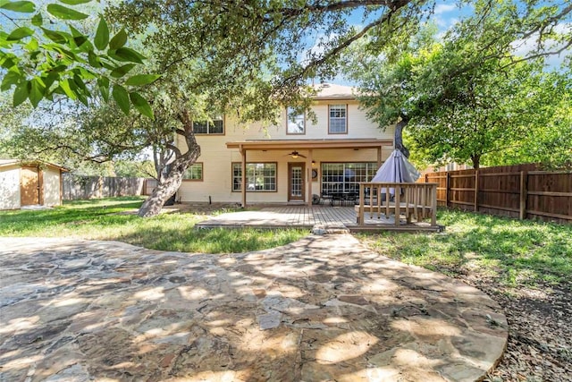 6100 Open Range Trl, Austin, TX 78749 - back of property with a fenced backyard, ceiling fan, and a wooden deck