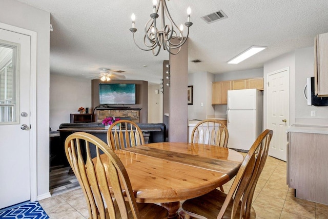 2101 Barnett Dr, Cedar Park, TX 78613 - dining room featuring light tile patterned floors, ceiling fan, a textured ceiling, and a chandelier