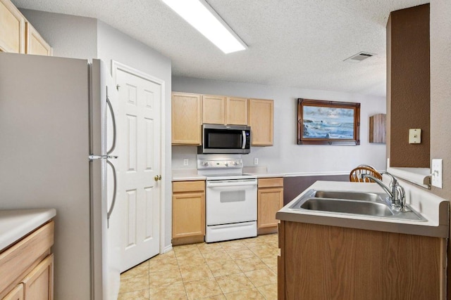 2101 Barnett Dr, Cedar Park, TX 78613 - kitchen featuring white appliances, light brown cabinets, a textured ceiling, and light tile patterned flooring