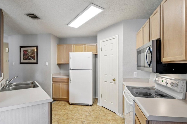 2101 Barnett Dr, Cedar Park, TX 78613 - kitchen with white appliances, light brown cabinetry, a textured ceiling, light countertops, and light tile patterned floors