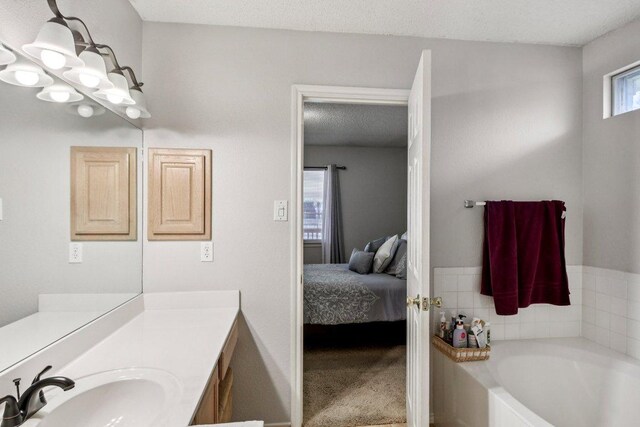 2101 Barnett Dr, Cedar Park, TX 78613 - ensuite bathroom featuring vanity and a garden tub