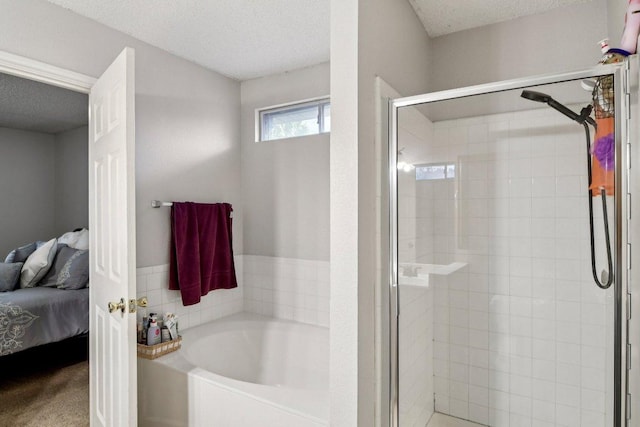 2101 Barnett Dr, Cedar Park, TX 78613 - ensuite bathroom with a bath, a stall shower, and a textured ceiling