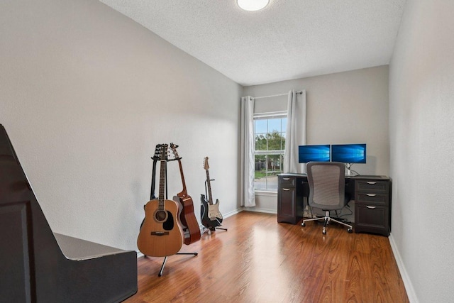 2101 Barnett Dr, Cedar Park, TX 78613 - office area with wood finished floors and a textured ceiling