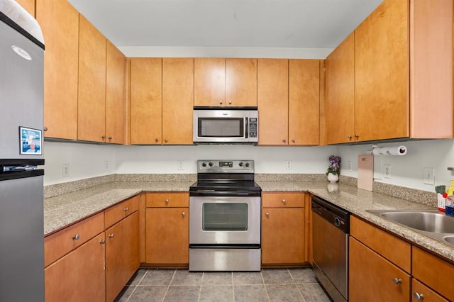 2502 Leon St Unit 102, Austin, TX 78705 - kitchen with appliances with stainless steel finishes, light countertops, and light tile patterned flooring
