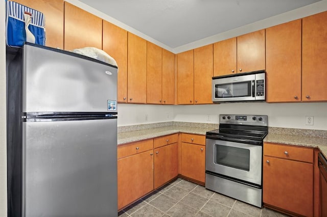 2502 Leon St Unit 102, Austin, TX 78705 - kitchen featuring stainless steel appliances, light countertops, and light tile patterned floors