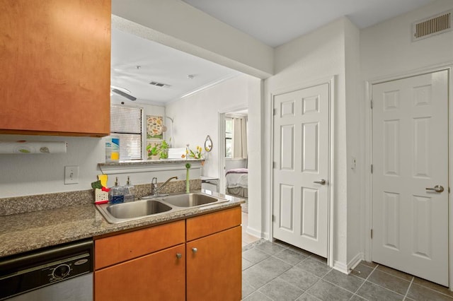 2502 Leon St Unit 102, Austin, TX 78705 - kitchen with dishwasher, tile patterned flooring, ceiling fan, and brown cabinets