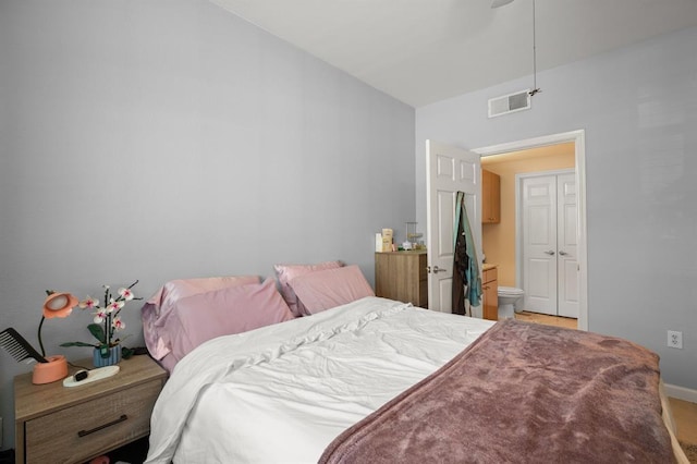 2502 Leon St Unit 102, Austin, TX 78705 - bedroom with connected bathroom and light carpet