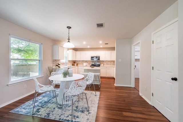 8716 Corran Ferry Dr, Austin, TX 78749 - dining space featuring dark wood-style floors and recessed lighting