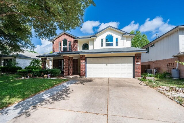8716 Corran Ferry Dr, Austin, TX 78749 - traditional home with an attached garage, brick siding, concrete driveway, and a front lawn