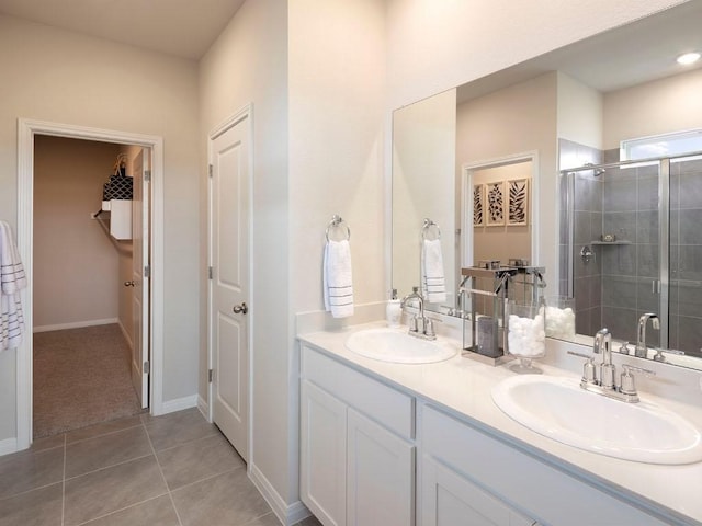 716 Sun Grove Trl, Georgetown, TX 78628 - bathroom featuring a shower stall, double vanity, and tile patterned floors