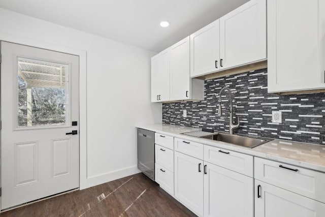 304 Harris St, Smithville, TX 78957 - kitchen featuring stainless steel dishwasher, backsplash, dark wood-type flooring, white cabinetry, and recessed lighting