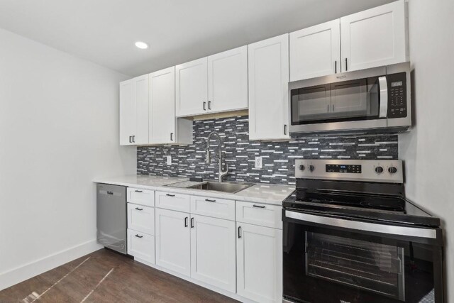 304 Harris St, Smithville, TX 78957 - kitchen featuring stainless steel appliances, light countertops, decorative backsplash, white cabinets, and recessed lighting