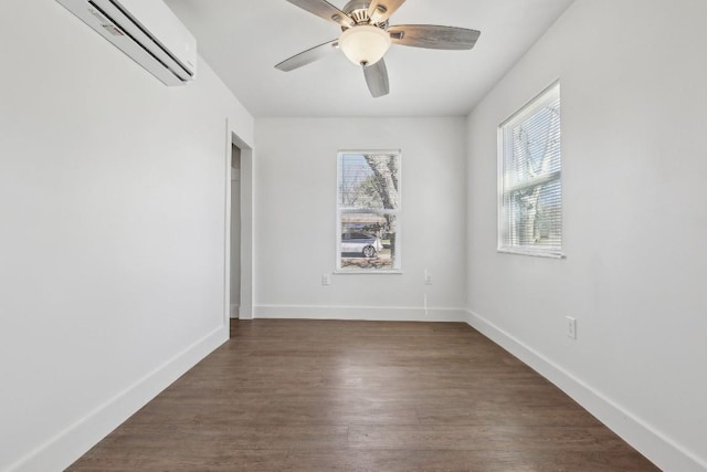 304 Harris St, Smithville, TX 78957 - empty room with an AC wall unit, dark wood finished floors, and ceiling fan