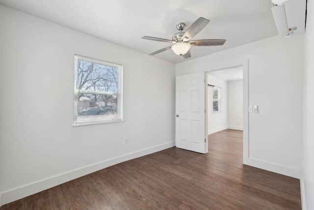 304 Harris St, Smithville, TX 78957 - unfurnished bedroom with dark wood finished floors and a ceiling fan