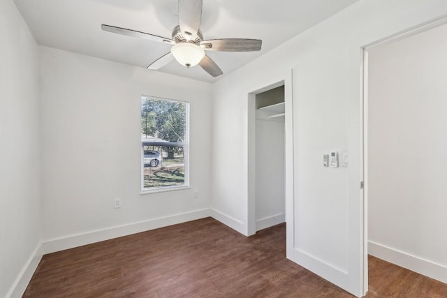 304 Harris St, Smithville, TX 78957 - unfurnished bedroom with wood finished floors, a closet, ceiling fan, and a walk in closet