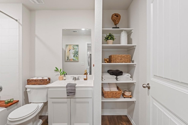 11817 Rush Ln, Elgin, TX 78621 - bathroom featuring vanity, a shower, and wood finished floors