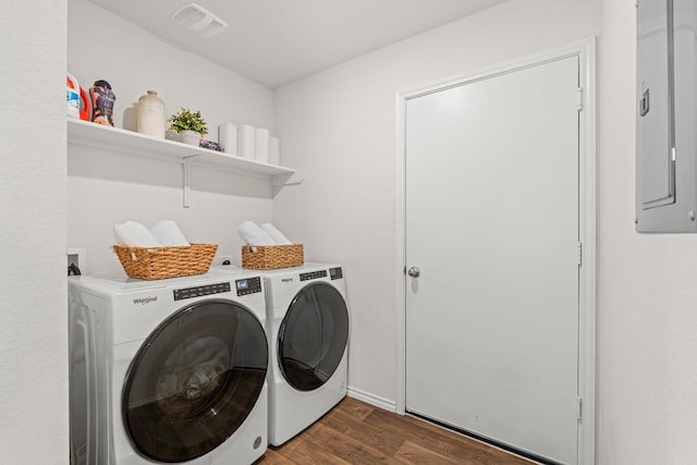 11817 Rush Ln, Elgin, TX 78621 - laundry area featuring washing machine and dryer, wood finished floors, and electric panel