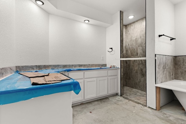 2115 Blackhawk Loop, Belton, TX 76513 - bathroom with a tile shower, a freestanding bath, concrete floors, and vanity