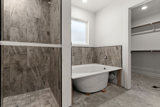 2115 Blackhawk Loop, Belton, TX 76513 - bathroom with a walk in closet, a freestanding bath, a shower stall, and recessed lighting