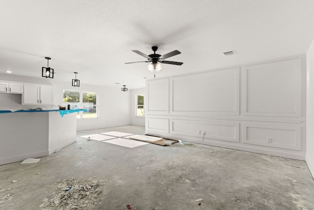 2115 Blackhawk Loop, Belton, TX 76513 - unfurnished living room featuring a ceiling fan and unfinished concrete flooring