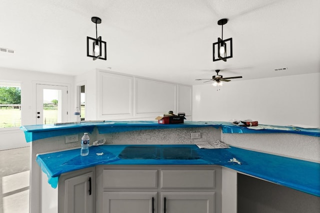 2115 Blackhawk Loop, Belton, TX 76513 - kitchen featuring pendant lighting, a ceiling fan, white cabinets, and dark countertops