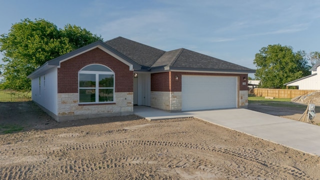 2119 Blackhawk Loop, Belton, TX 76513 - single story home with a shingled roof, stone siding, an attached garage, concrete driveway, and brick siding