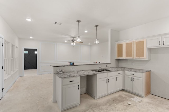 2119 Blackhawk Loop, Belton, TX 76513 - kitchen with a peninsula, light stone counters, a ceiling fan, white cabinets, and recessed lighting