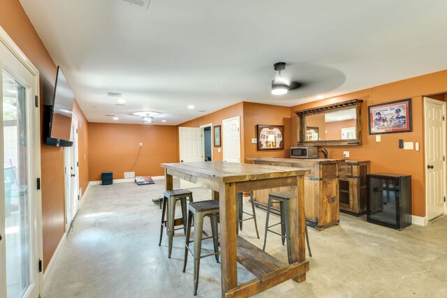 704 Deckhouse Dr, Lago Vista, TX 78645 - kitchen featuring stainless steel microwave, wine cooler, finished concrete floors, and recessed lighting