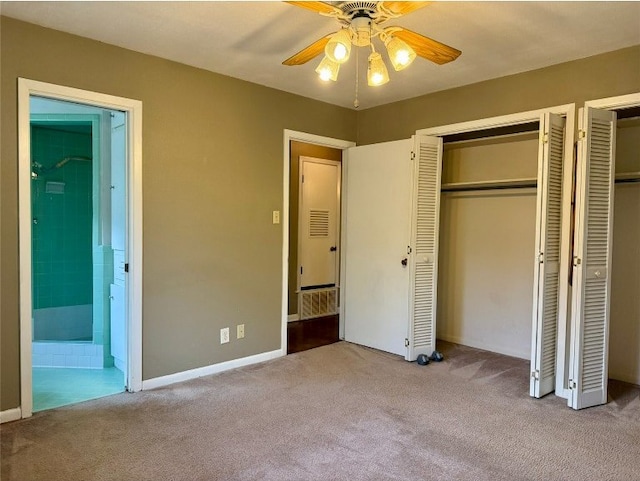11601 Oak Trl, Austin, TX 78753 - unfurnished bedroom with carpet floors, two closets, ensuite bathroom, and a ceiling fan