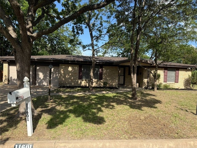 11601 Oak Trl, Austin, TX 78753 - view of front of property featuring brick siding, an attached garage, concrete driveway, and a front yard