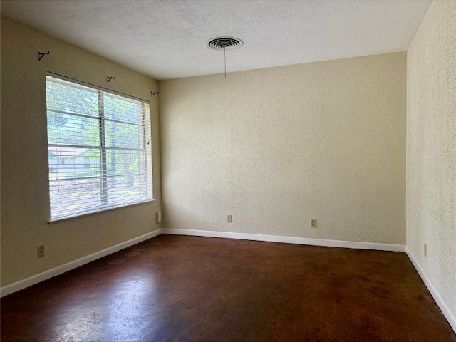 11601 Oak Trl, Austin, TX 78753 - unfurnished room featuring concrete floors and a textured wall