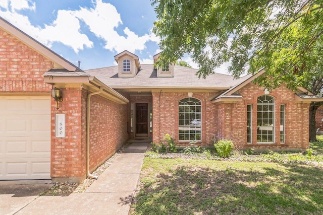 800 Mountain Ridge Dr, Leander, TX 78641 - view of front facade with brick siding, an attached garage, and a shingled roof