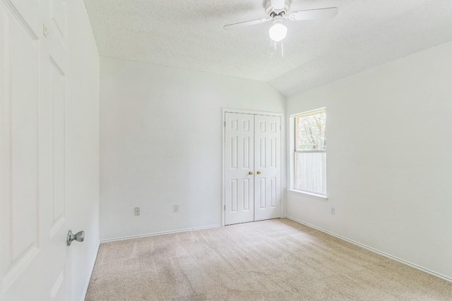 800 Mountain Ridge Dr, Leander, TX 78641 - unfurnished bedroom with carpet floors, lofted ceiling, a textured ceiling, a closet, and a ceiling fan