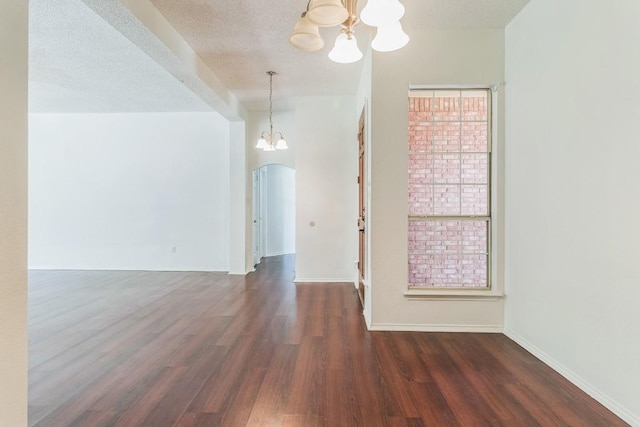 800 Mountain Ridge Dr, Leander, TX 78641 - unfurnished dining area featuring a chandelier, wood finished floors, and arched walkways