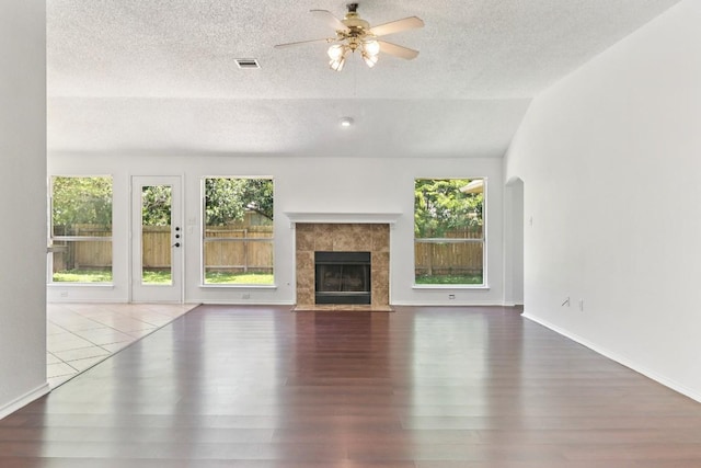 800 Mountain Ridge Dr, Leander, TX 78641 - unfurnished living room with a textured ceiling, a ceiling fan, wood finished floors, and plenty of natural light