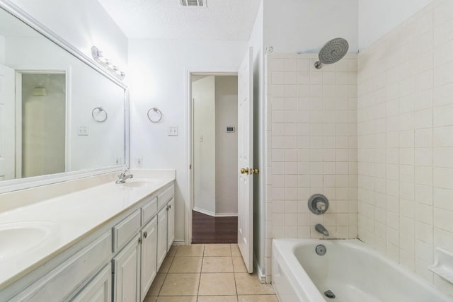 800 Mountain Ridge Dr, Leander, TX 78641 - full bath featuring tile patterned floors, double vanity, shower / tub combination, and a textured ceiling