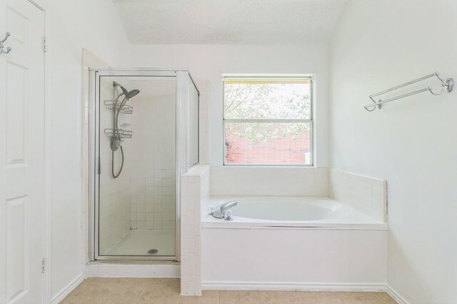 800 Mountain Ridge Dr, Leander, TX 78641 - bathroom featuring a garden tub, a shower stall, and tile patterned flooring