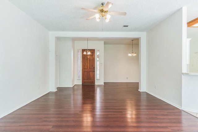 800 Mountain Ridge Dr, Leander, TX 78641 - unfurnished room with wood finished floors, a ceiling fan, a textured ceiling, and a chandelier