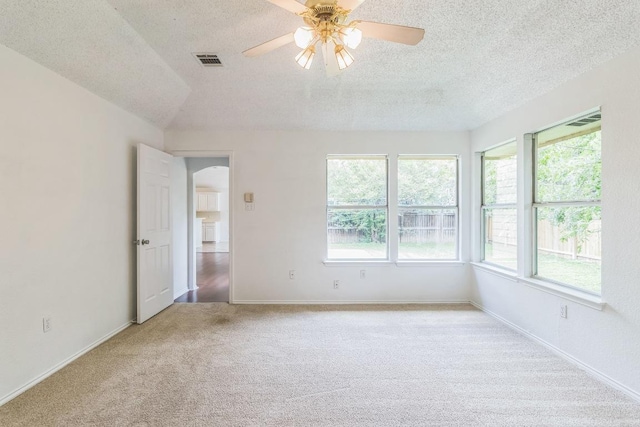 800 Mountain Ridge Dr, Leander, TX 78641 - carpeted spare room with a textured ceiling, arched walkways, and a ceiling fan