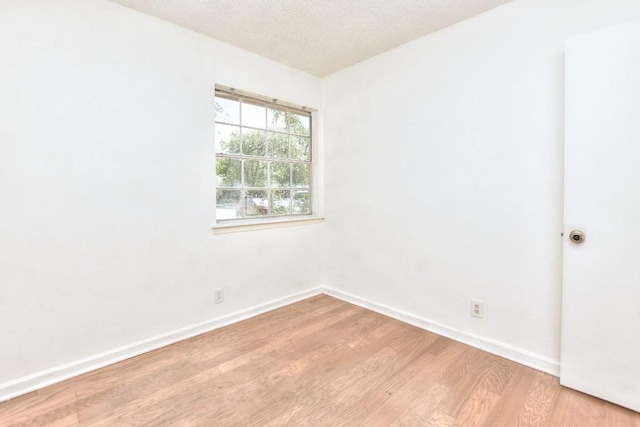 803 Easy Day Cv, Austin, TX 78745 - unfurnished room with light wood finished floors and a textured ceiling