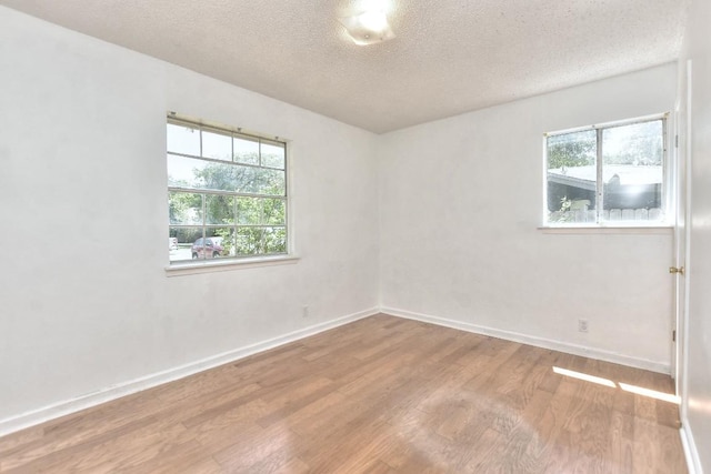 803 Easy Day Cv, Austin, TX 78745 - spare room with wood finished floors and a textured ceiling
