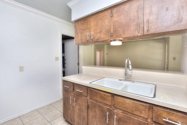 803 Easy Day Cv, Austin, TX 78745 - kitchen featuring light tile patterned floors, light countertops, crown molding, and brown cabinets