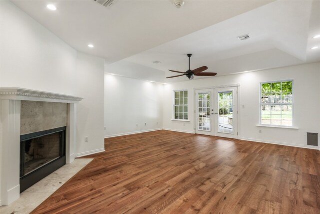 1708 Shag Bark Trl, Austin, TX 78758 - unfurnished living room featuring wood finished floors, ceiling fan, a fireplace, french doors, and recessed lighting