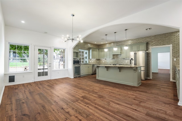1708 Shag Bark Trl, Austin, TX 78758 - kitchen featuring wine cooler, appliances with stainless steel finishes, arched walkways, dark wood-type flooring, and recessed lighting