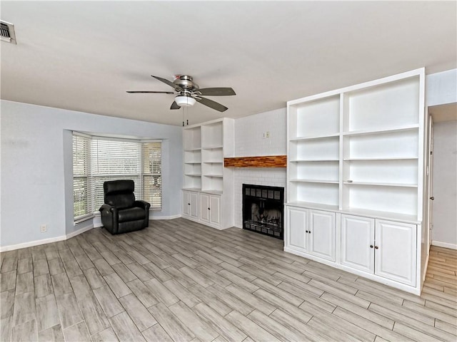1708 Shag Bark Trl, Austin, TX 78758 - unfurnished living room with ceiling fan, light wood-type flooring, and a brick fireplace