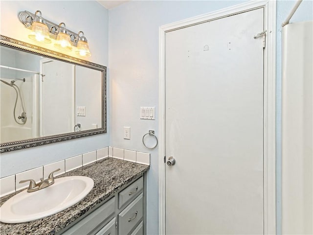 1708 Shag Bark Trl, Austin, TX 78758 - bathroom with vanity, a shower, and tasteful backsplash