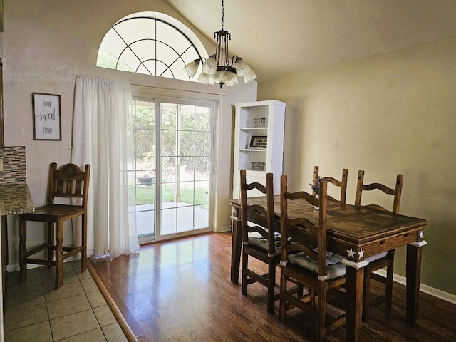 1202 Bowen Ave, Copperas Cove, TX 76522 - dining room with a chandelier, dark wood-type flooring, and vaulted ceiling
